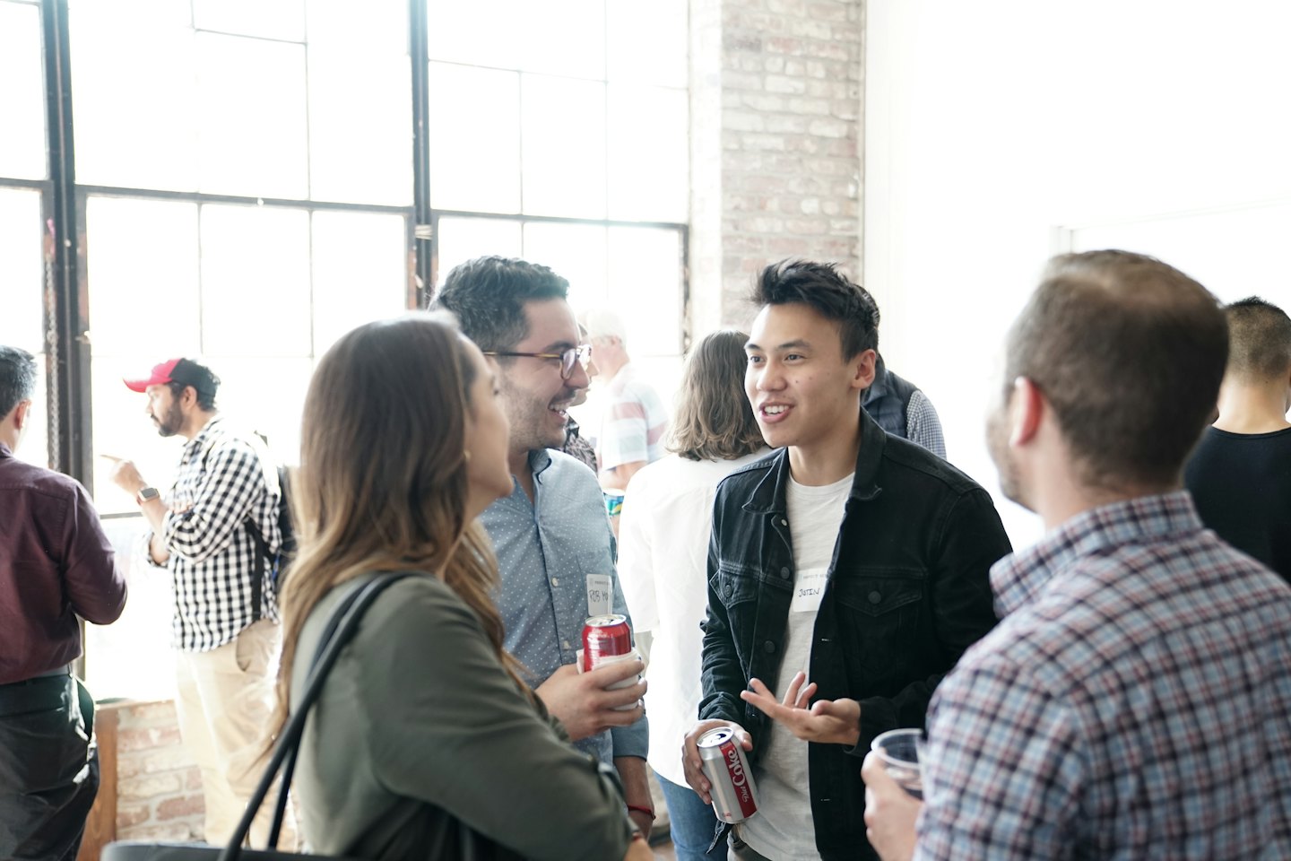 Diverse professionals networking and conversing at an indoor event.
